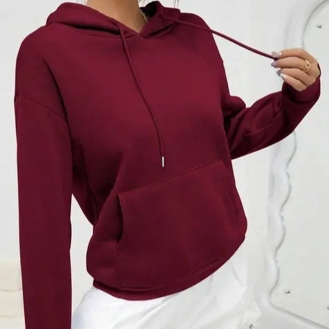 Maroon hoodie worn by a person on a white background